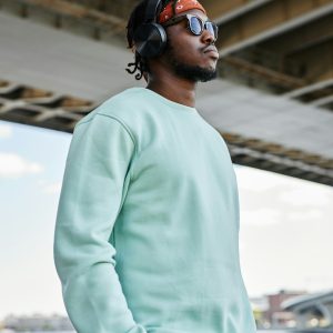Man wearing headphones in urban city setting outdoors